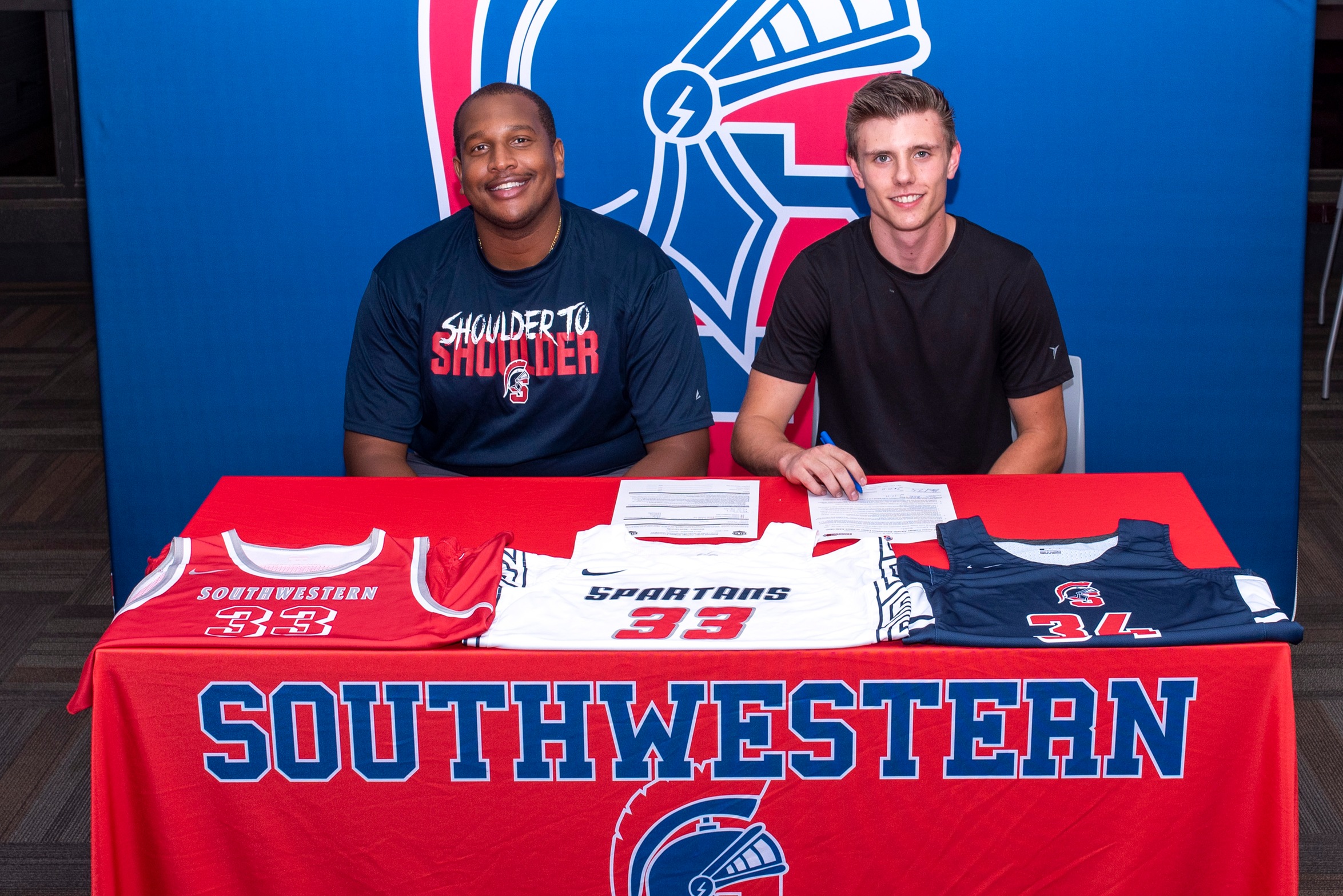 Carson Busch signs his National Letter of Intent to join the Southwestern men's basketball team.