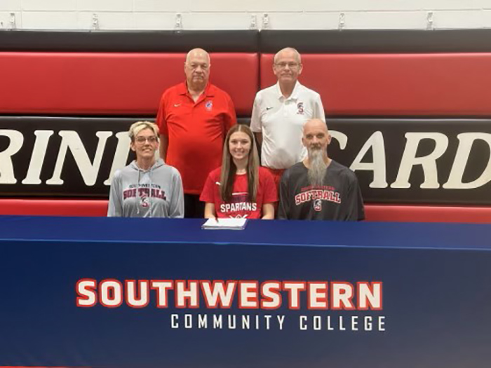 Sitting (L to R): Michelle Sunderman, Ryplee's mother; Ryplee Sunderman; and Chad Sunderman, Ryplee's father. Standing: Dan Gibbons, Southwestern assistant softball coach, and Danny Jensen, Southwestern head softball coach.