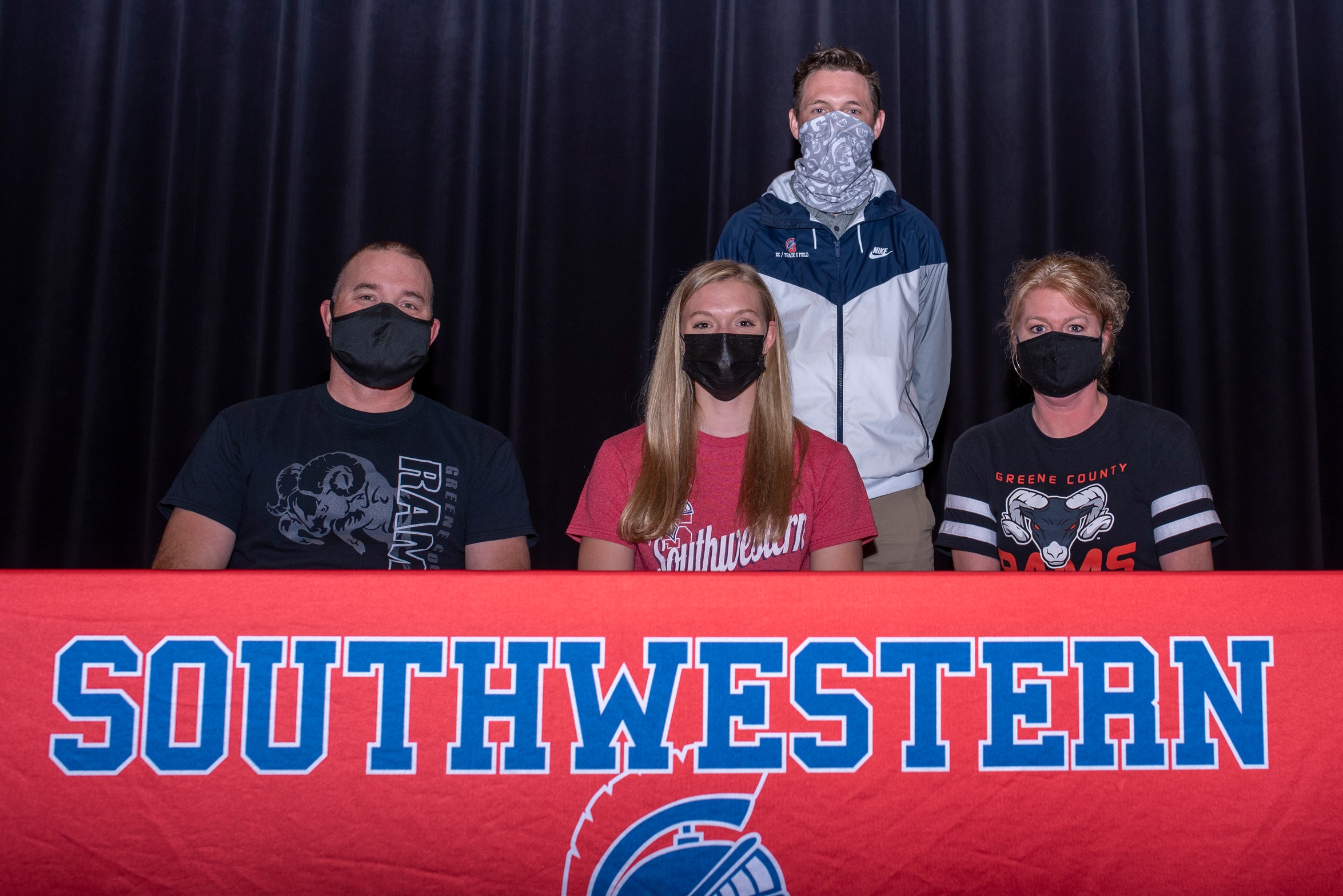 Brianna Osterson, center, signs her National Letter of Intent with Southwestern Community College to run track and field. Also pictured are Brianna's parents Jim and Lynnae Osterson, and Southwestern Director of Cross Country/Track & Field Scott Vicker.