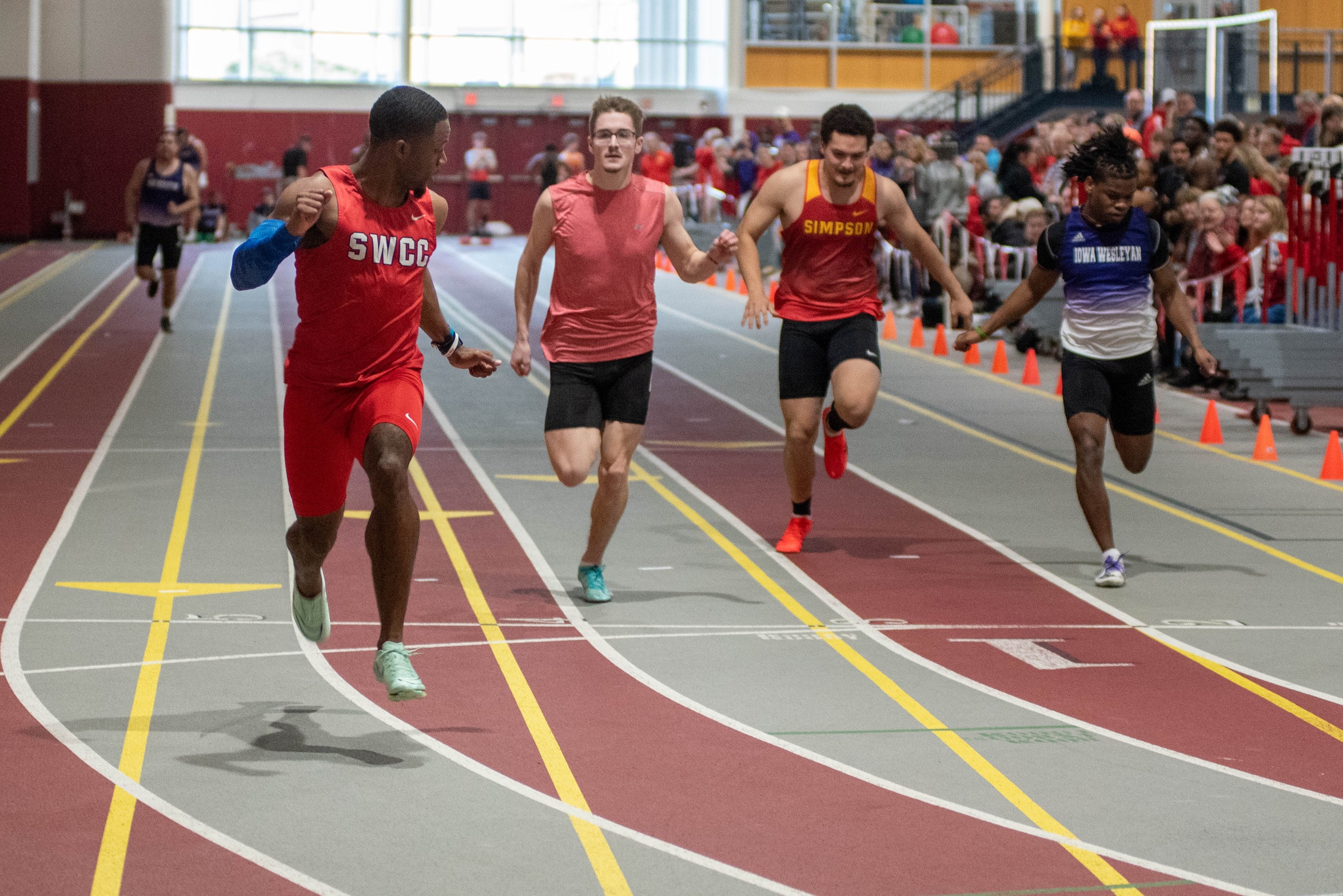 Justin Cunningham runs away from the field in the men's 60 meter dash