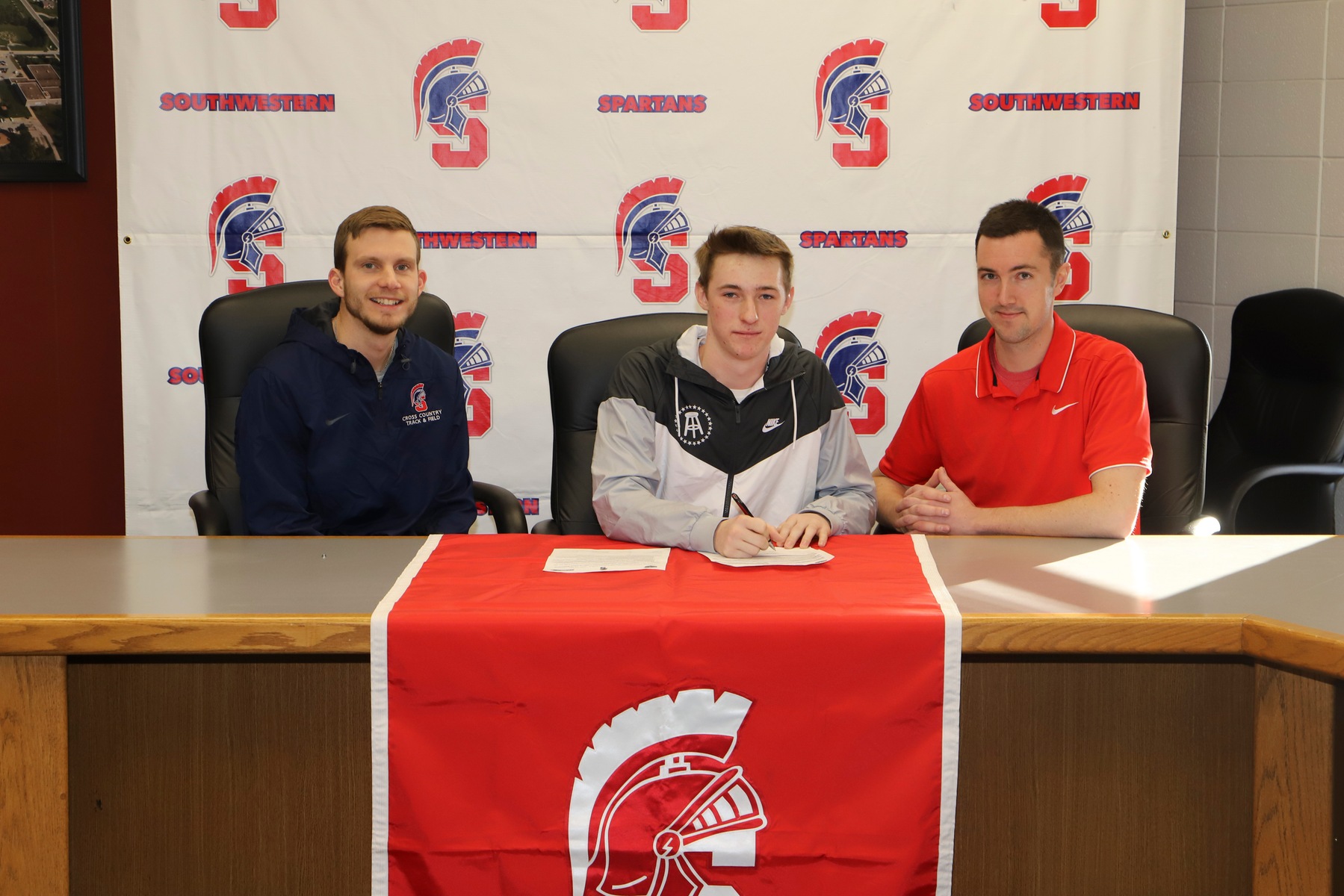 Central Decatur's Kolten Johnson signs his letter of intent with Southwestern for the 2019-20 track and field season.