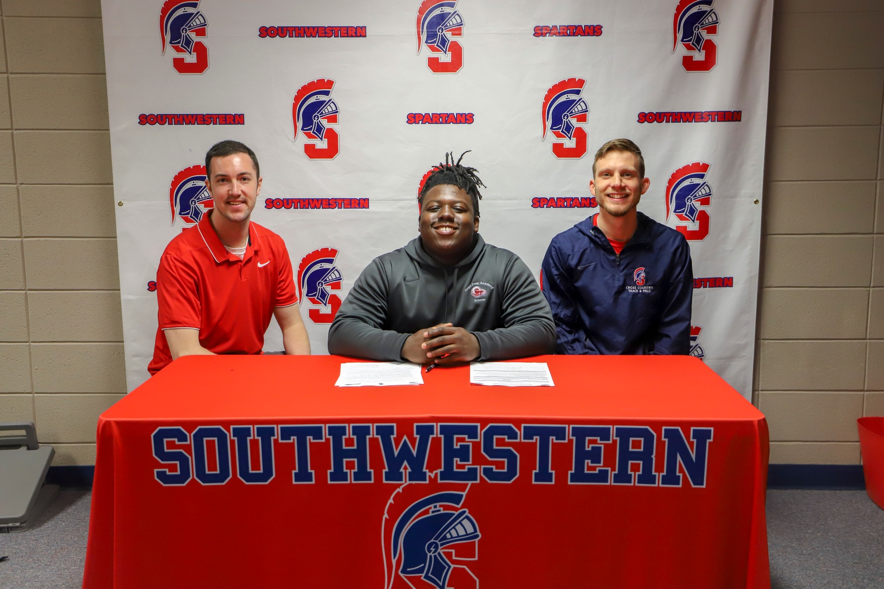 Marquez Jenkins of Kansas City, Missouri, signs his National Letter of Intent to throw for the Southwestern track and field team.