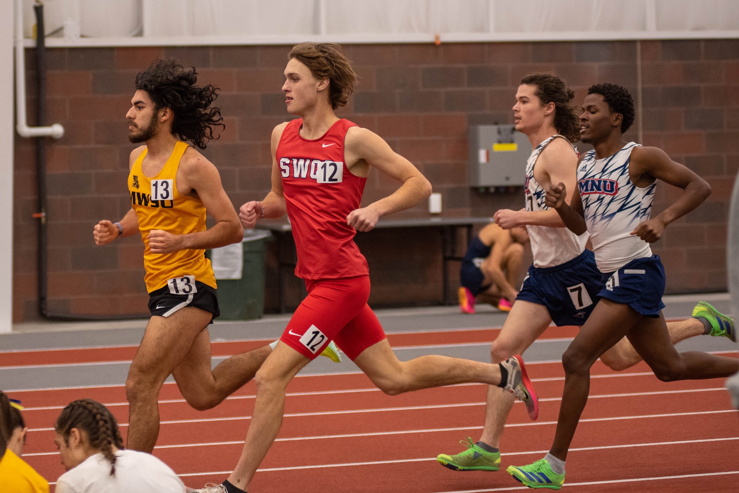 Chase Oates runs the mile at the Northwest Open