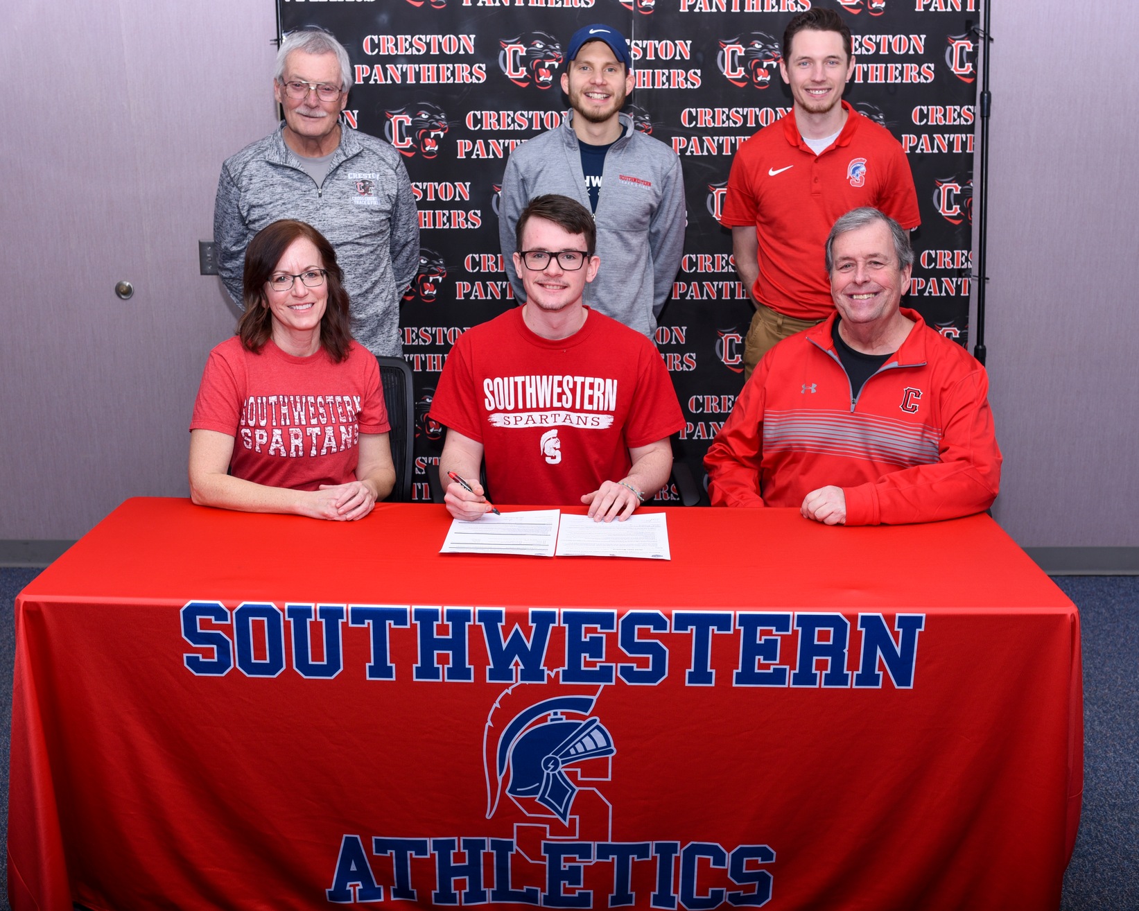 Creston's Jared Moreland signs his National Letter of Intent to run cross country and track and field at Southwestern Community College.