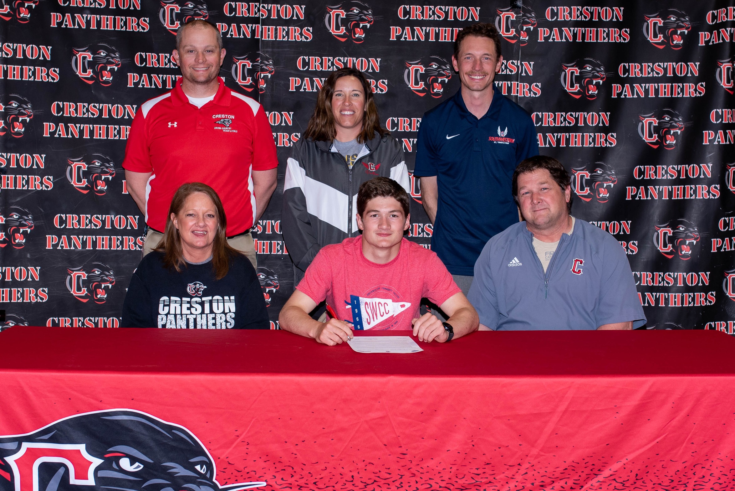 Brandon Briley, center, signs his National Letter of Intent to run cross country and track at Southwestern next year. Also pictured, in front, are his parents Treana and Chad Briley. In back, from left, are Creston track coaches Clay and Maggie Arnold, and SWCC cross country/track coach Scott Vicker.