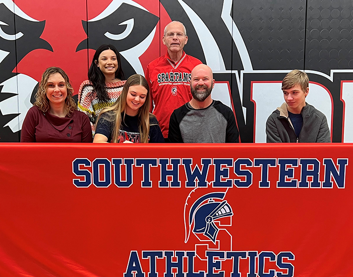 Pictured - Sitting (L to R) ? Charleen Ostrem, Cora?s mother; Cora Ostrem; Jason Ostrem, Cora?s father; and Riley Ostrem, Cora?s brother. Standing ? Claudia Farrell, Cora?s pitching coach, and Danny Jensen, SWCC head softball coach.