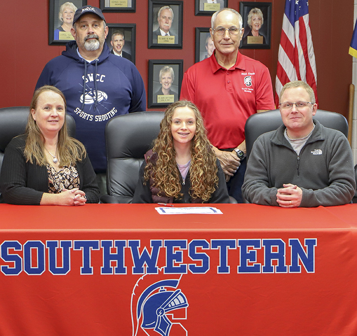 In photo (L to R):  Sitting – Angie Kelso, Katie’s mother; Katie Kelso; and Jeff Kelso, Katie’s father. Standing – Tom King, Southwestern assistant sports shooting coach, and Marc Roberg, Southwestern head sports shooting coach.