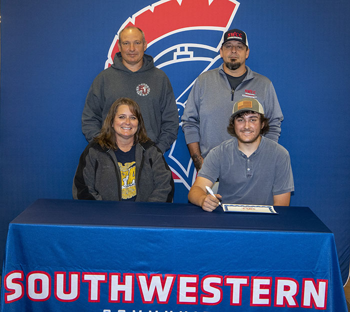 Sitting: Melanie and Ethan Mitchell.
Standing: Scott Mitchell and Josh Purdy, SWCC sports shooting coach