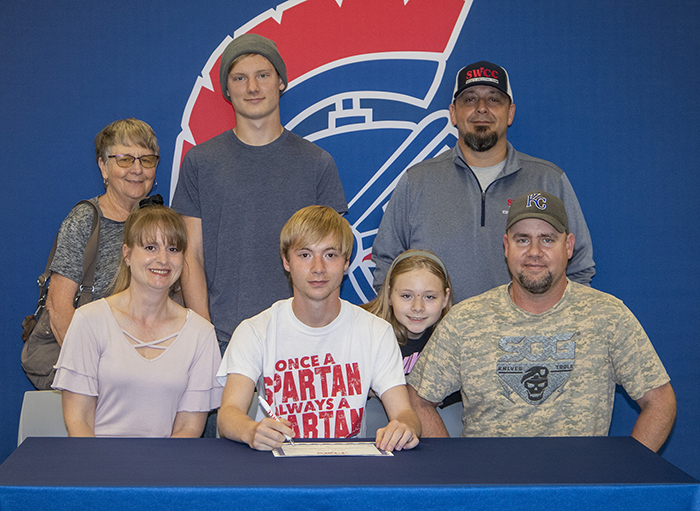 Sitting (L to R): Cora Haley, Nathaniel's mother; Nathaniel Wells; and Frank Wells, Nathaniel's father.
Standing: Lee Wells, Nathaniel's grandmother; Chris Wells, Nathaniel's brother; Kaylee Wells, Nathaniel's sister (leaning); and Josh Purdy, Southwestern sports shooting coach.