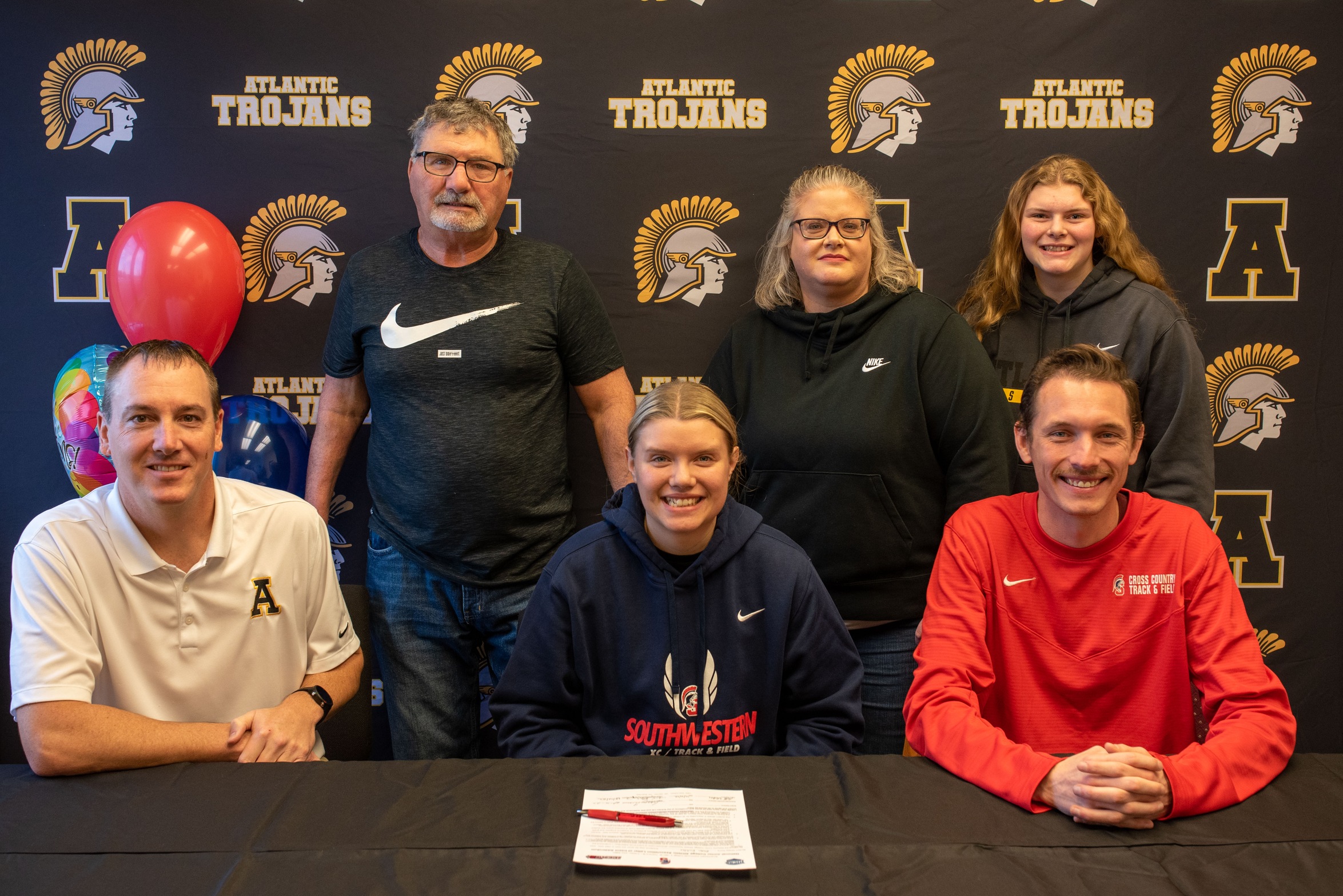 Abbi Richter signs her LOI to join the Southwestern track & field program in the 2023-24 season. Pictured, in front from left, are Matt Mullenix, Atlantic girls track coach; Abbi Richter; and Scott Vicker, Southwestern director of cross country/track & field. In back, from left, are Richter's parents, Brian and Jennifer Richter; and sister Maddie Richter.